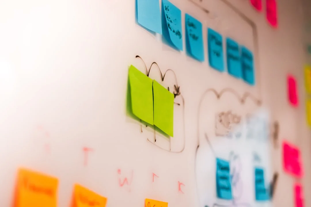 services-03 Sticky notes displaying holiday marketing ideas are clipped to a wall grid.